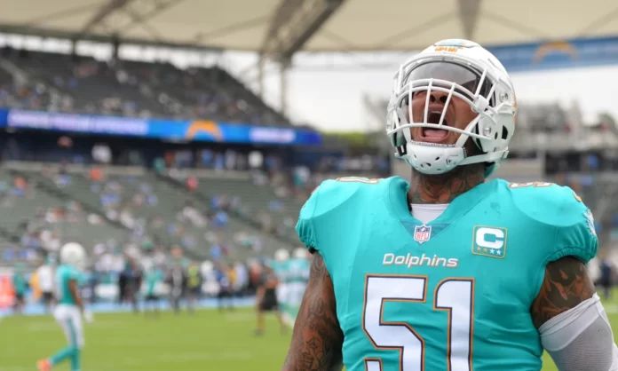 Miami Dolphins offensive lineman Mike Pouncey (51) gets pumped on the sidelines.