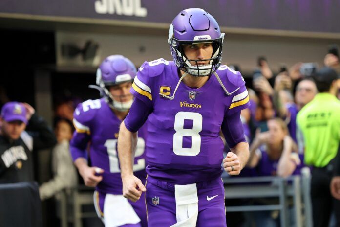 Kirk Cousins runs onto the field before a Wild Card game against the New York Giants.