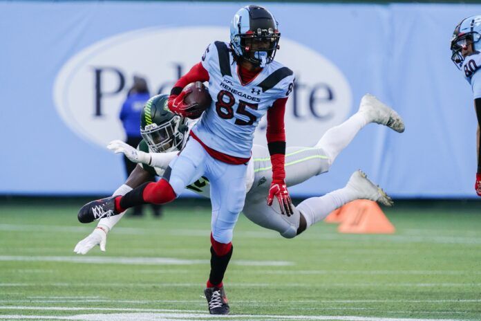 Arlington Renegades WR Tyler Vaughns (85) is being chased by a Guardians defender.