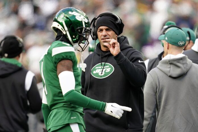 Robert Saleh talks to cornerback Sauce Gardner on the sideline during the first half against the Detroit Lions.