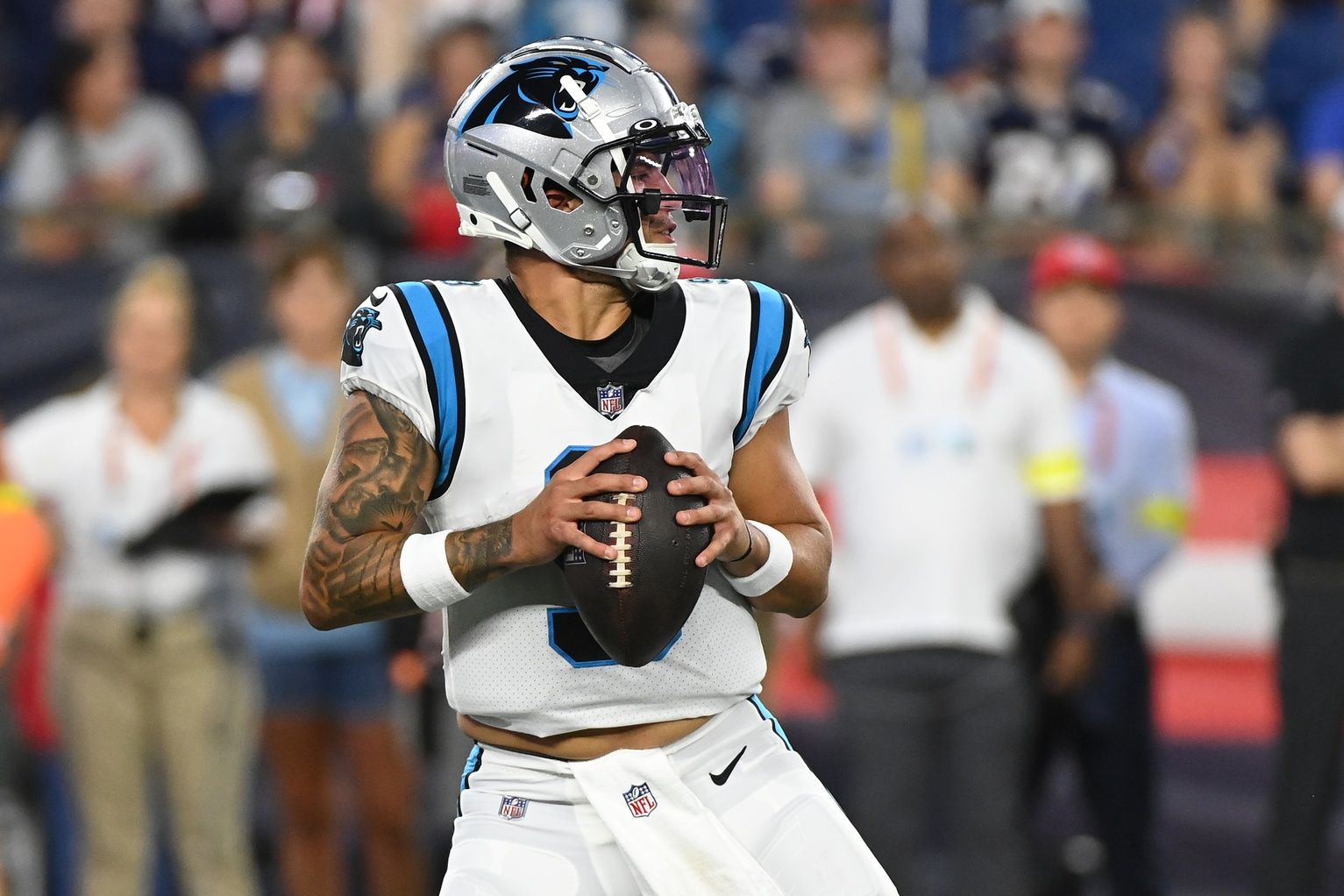 Matt Corral drops back to pass during the first half of a preseason.