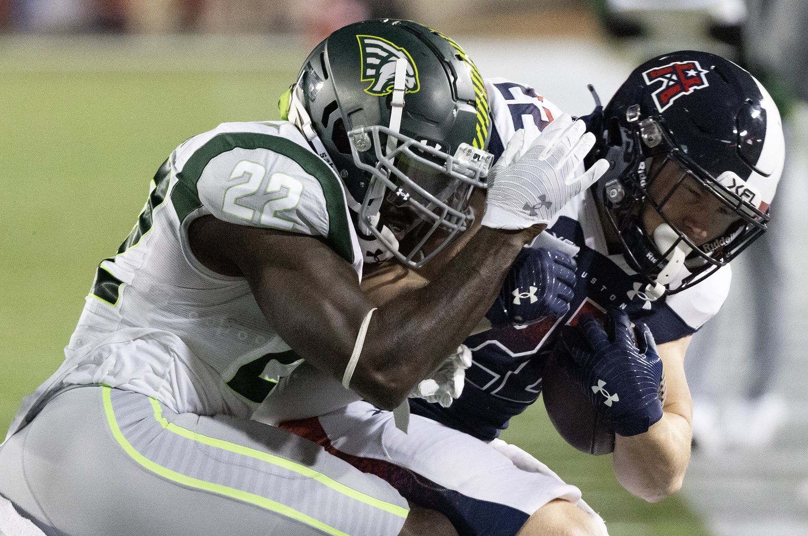 Houston Roughnecks running back Max Borghi (22) bis tackled by Orlando Guardians defensive back Matt Elam (22).