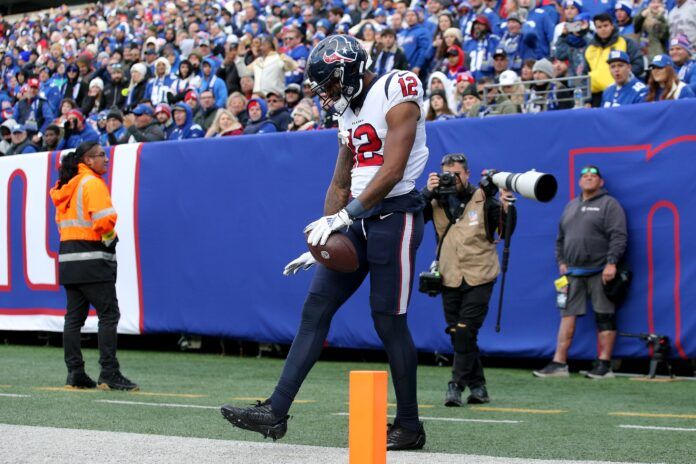 Nico Collins celebrates after catching a touchdown pass against the New York Giants.