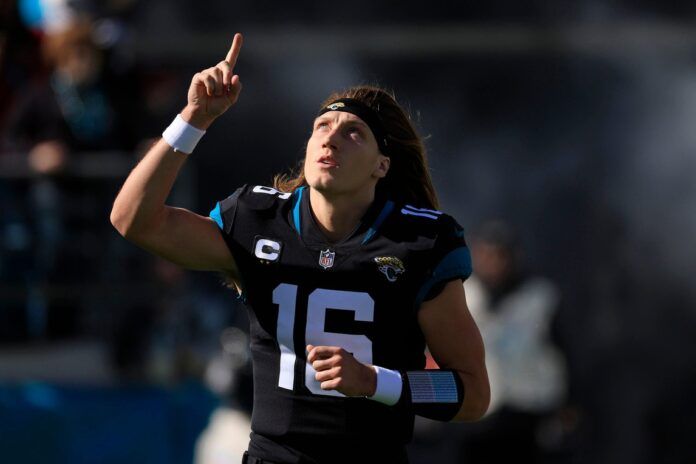 Trevor Lawrence takes to the field pointing skyward.