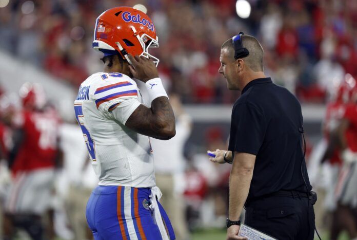 Billy Napier talks with quarterback Anthony Richardson during the second half against the Georgia Bulldogs.