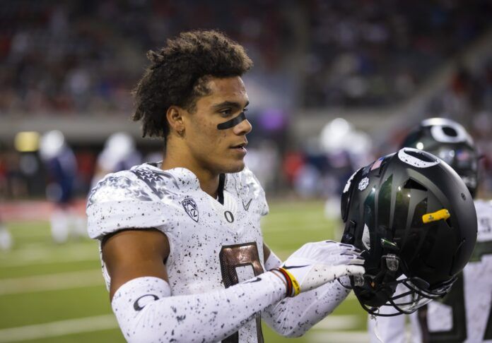 Christian Gonzalez puts his helmet on against the Arizona Wildcats.