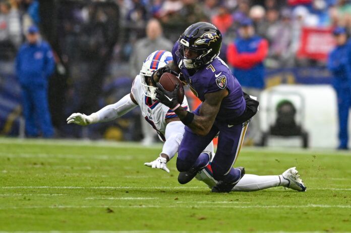 Rashod Bateman catches a pass as Buffalo Bills safety Damar Hamlin defends.