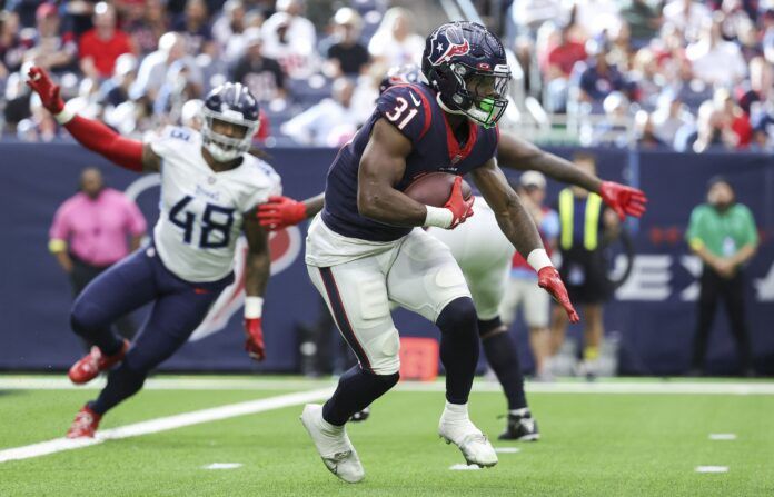 Houston Texans RB Dameon Pierce (31) runs with the ball past the Titans' defense.