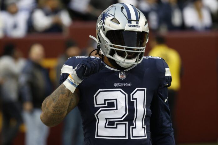 Ezekiel Elliott stands on the field during warmups prior to the Cowboys' game against the Washington Commanders.