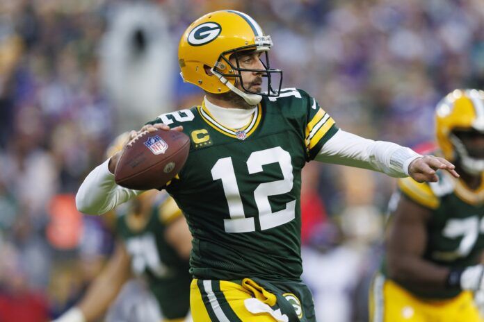 Aaron Rodgers winds up to throw a pass downfield.