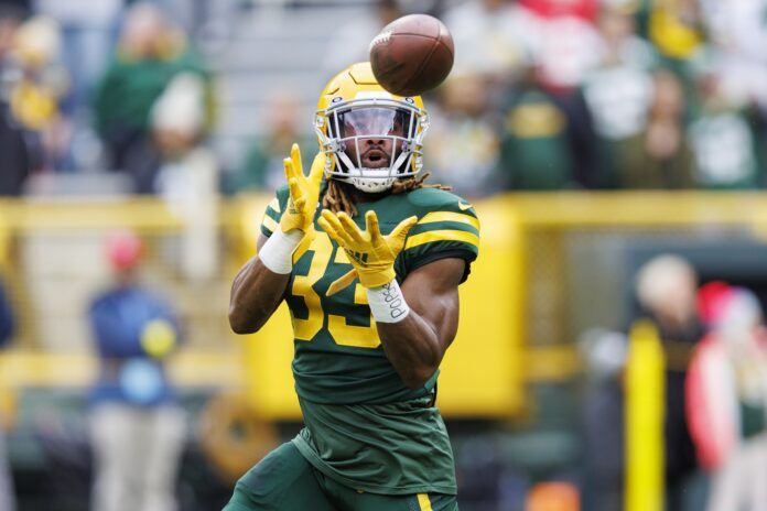 Aaron Jones catches a pass during warmups prior to the game against the Jets.