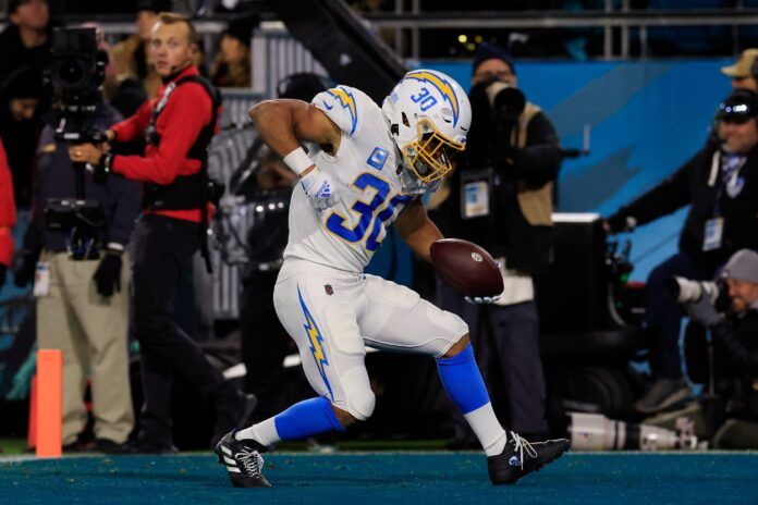 Austin Ekeler celebrates a touchdown score during the first quarter of an NFL first round playoff matchup.