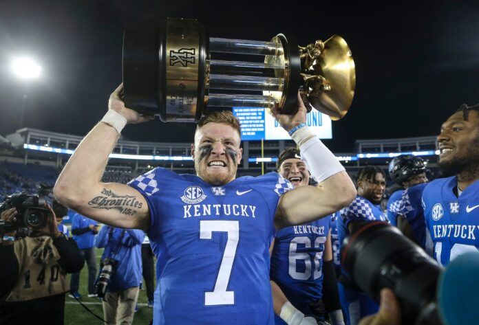 Will Levis grimaces while hoisting the 2022 Governor's Cup trophy.