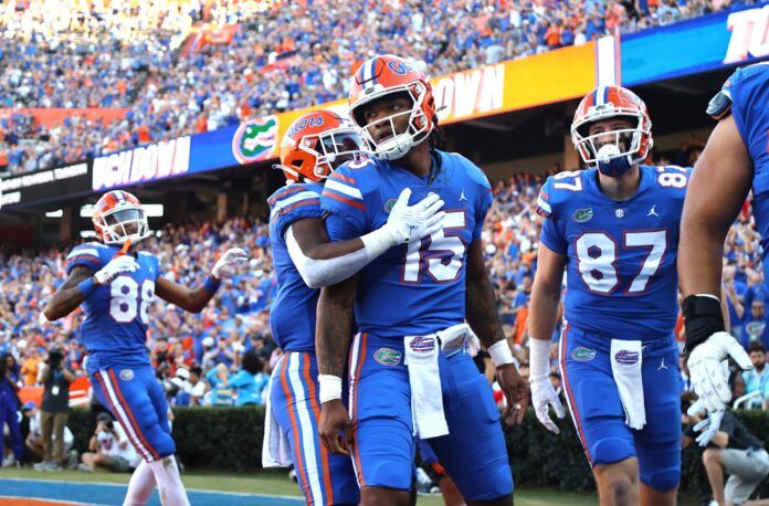 Florida QB Anthony Richardson (15) gets congratulated by teammates after scoring a touchdown.