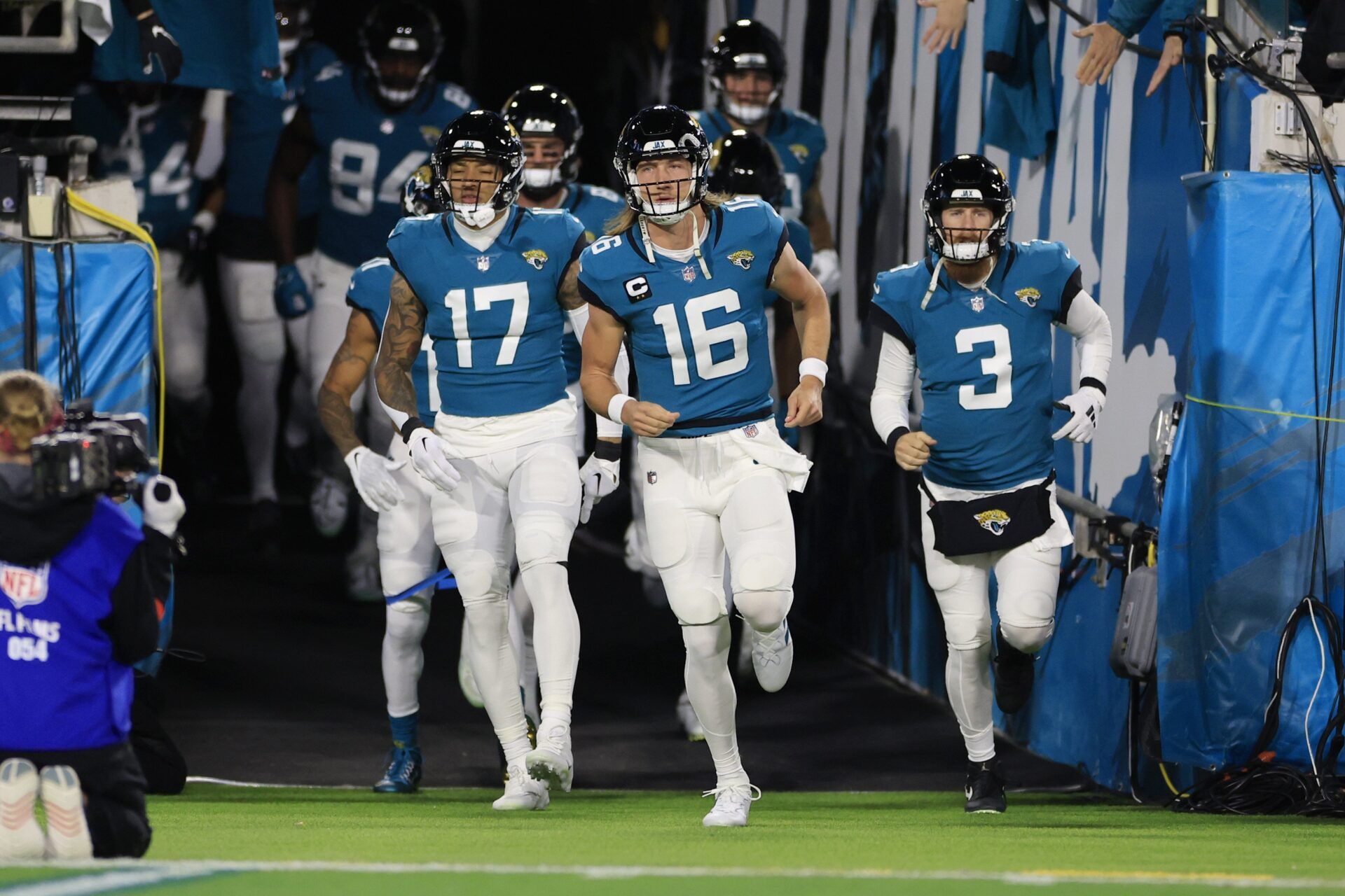 Trevor Lawrence takes to the field with teammates before facing the Chargers.
