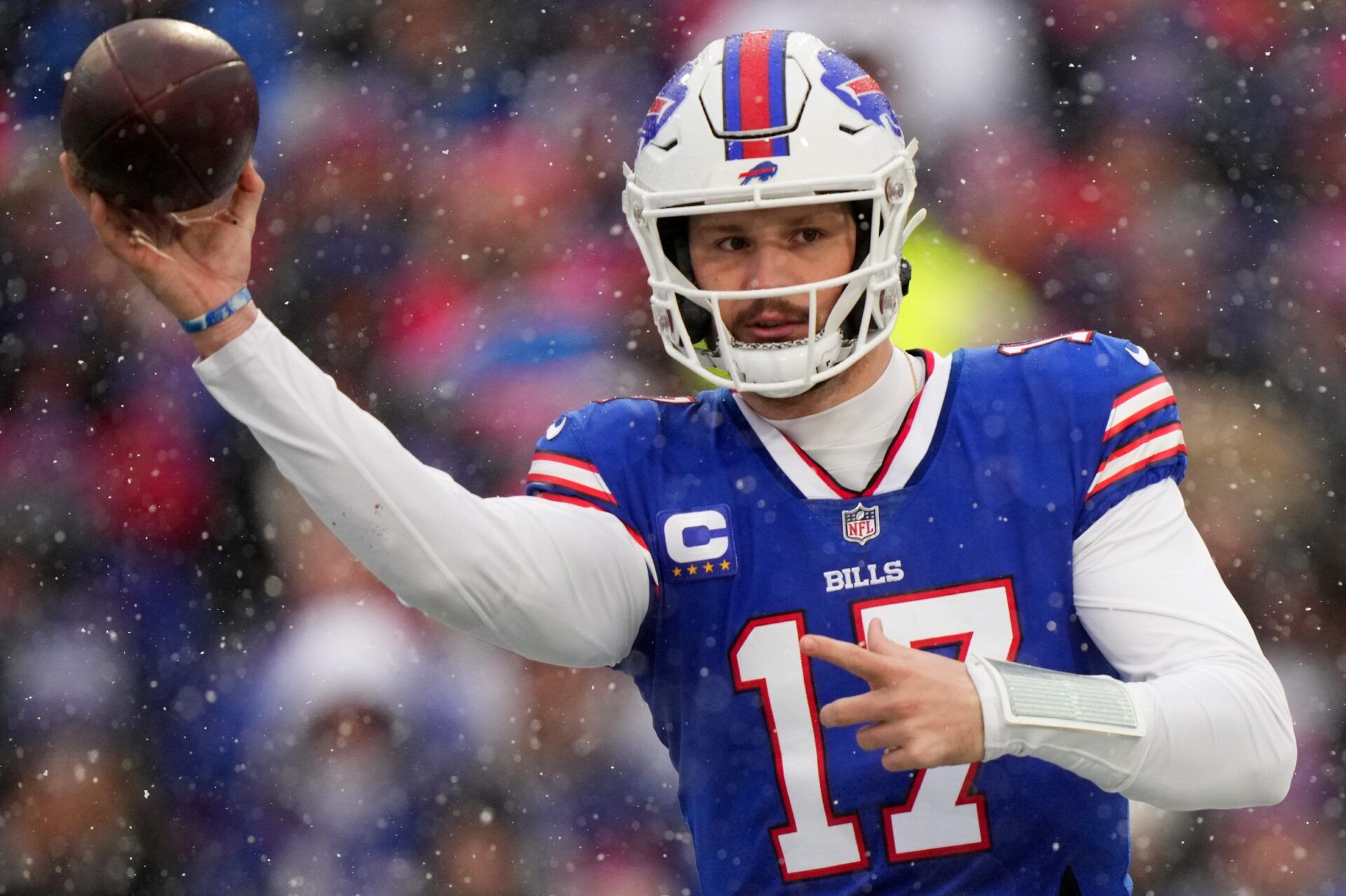Buffalo Bills QB Josh Allen (17) throws a pass in the snow.