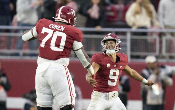 Alabama QB Bryce Young (9) celebrates with offensive lineman Javion Cohen (70).