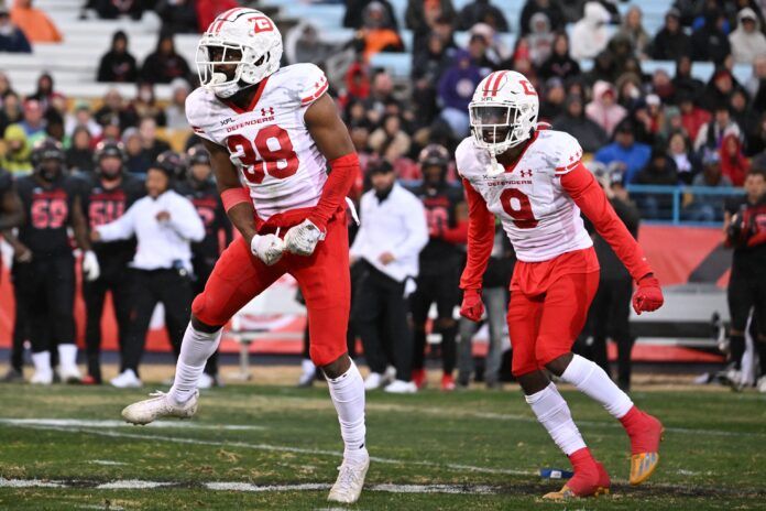 D.C. Defender DBs Nydair Rouse (38) and KJ.Sails (9) celebrate a tackle.