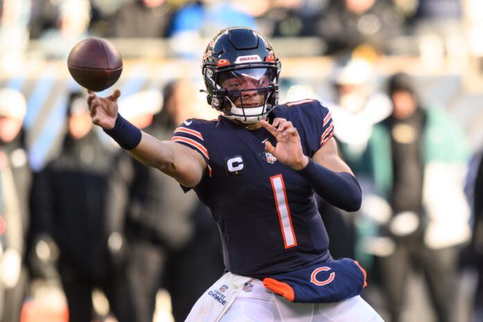 Justin Fields passes the ball against the Eagles.