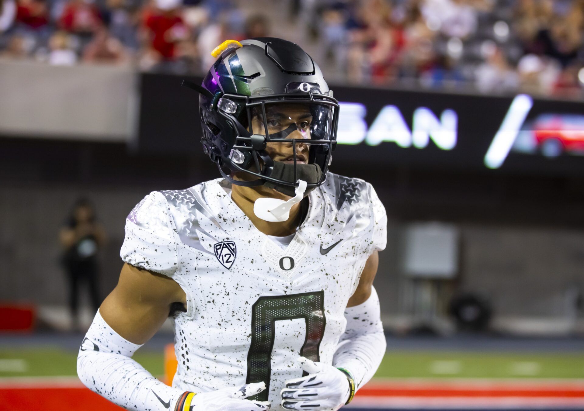 Oregon CB Christian Gonzalez jogs on the sidelines.