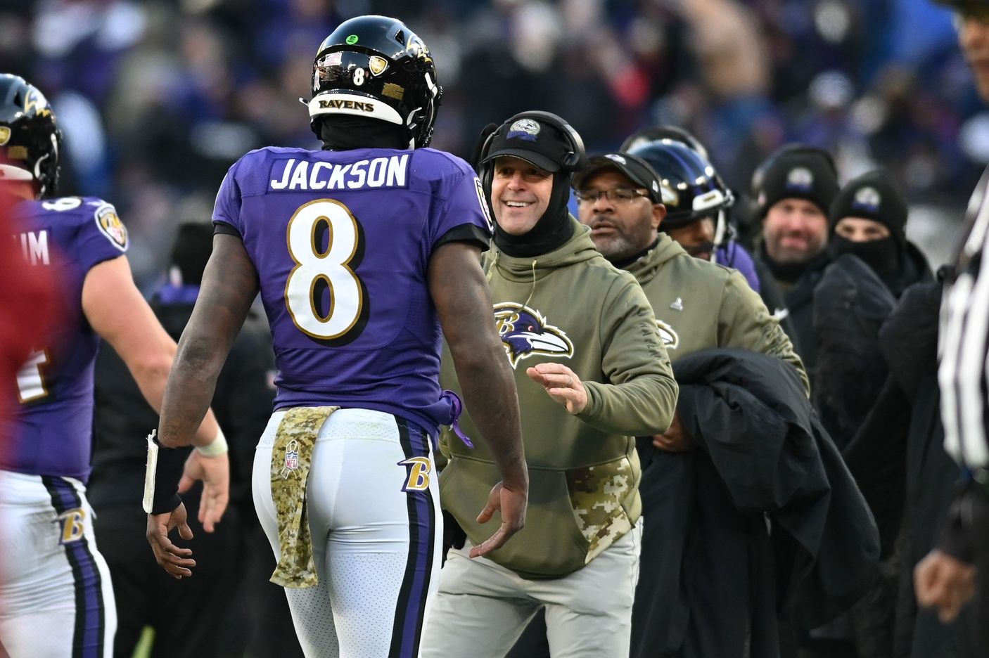 Baltimore Ravens head coach John Harbaugh greets quarterback Lamar Jackson (8) after scoring a second half touchdown against the Carolina Panthers.