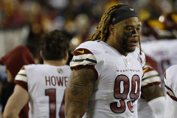 Washington Commanders DE Chase Young (99) stands on the sidelines against the Dallas Cowboys.