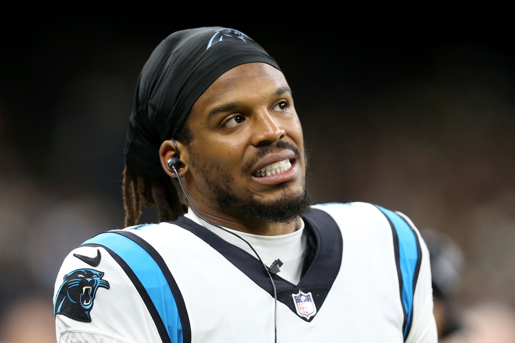 Carolina Panthers QB Cam Newton looks at the scoreboard from the sidelines.