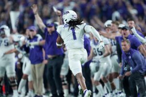 TCU Horned Frogs wide receiver Quentin Johnston (1) runs for a 76-yard touchdown after a catch against the Michigan Wolverines in the second half of the 2022 Fiesta Bowl at State Farm Stadium. 