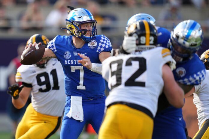 Kentucky QB Will Levis (7) attempts a pass against Iowa.