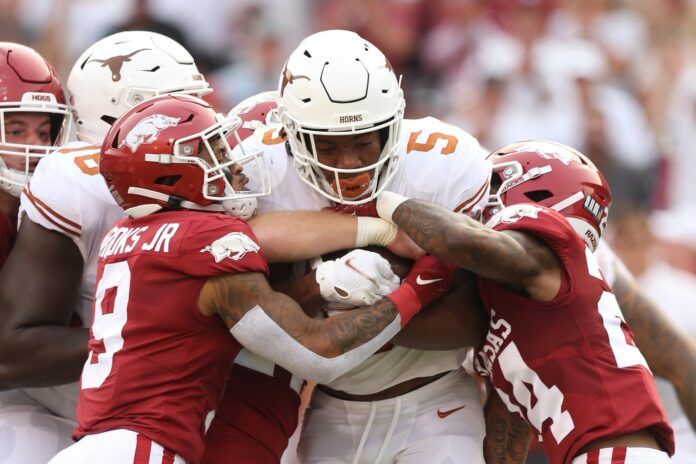 Bijan Robinson (5) is tackled by Arkansas Razorbacks defensive backs Greg Brooks Jr. (9) and LaDarrius Bishop (24).