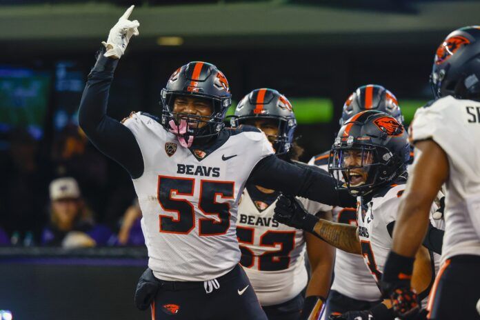 linebacker Easton Mascarenas-Arnold (55) celebrates with defensive back Jaydon Grant (3) after returning an interception.