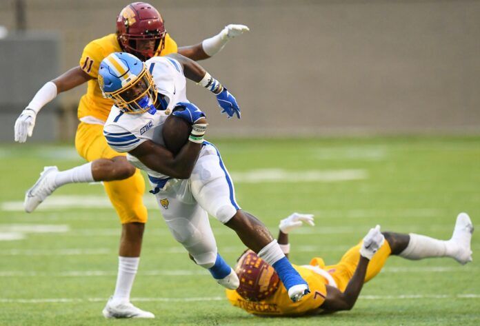 Emanuel Wilson (1) gets by Tuskegee defensive back Stanley Livingstone (11) and defensive back Antonio Kenos, Jr.,(7).