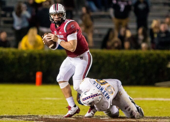 South Carolina Gamecocks quarterback Jake Bentley (19) looks to pass as Chattanooga Mocs defensive lineman Devonnsha Maxwell (90) attempts to bring him down.