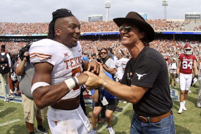 Texas RB Bijan Robinson (5) and actor Matthew McConaughey celebrate after the Longhorns' victory over Oklahoma.