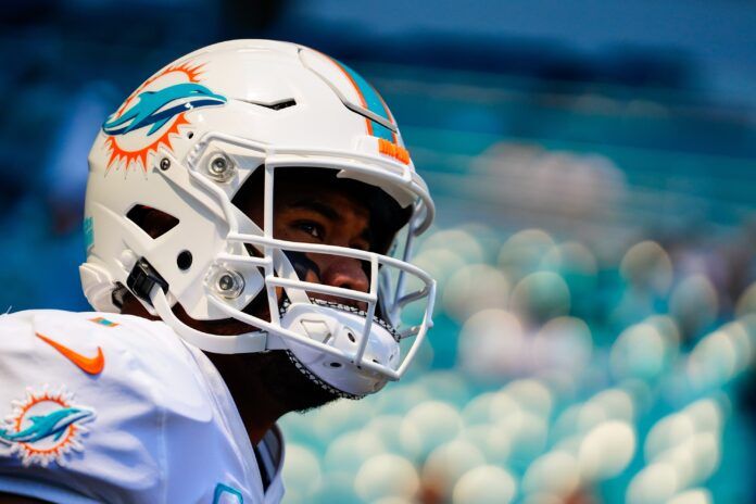 Miami Dolphins QB Tua Tagovailoa looks on.