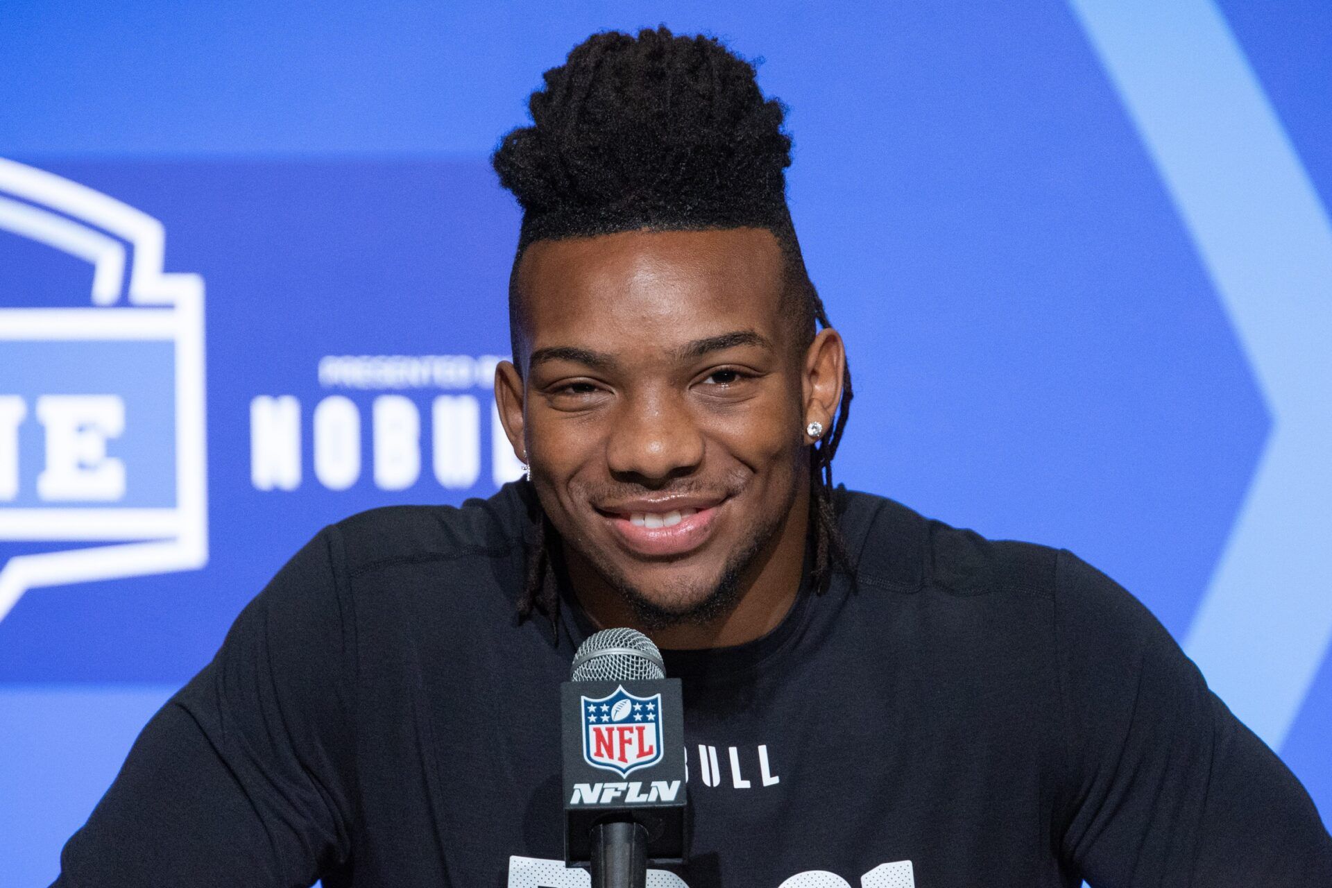 Texas RB Bijan Robinson smiles and laughs while speaking to the press at the NFL Combine.