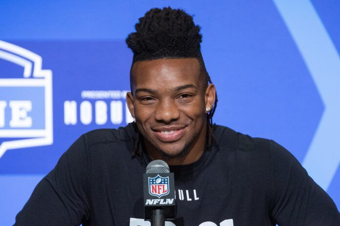 Texas RB Bijan Robinson smiles and laughs while speaking to the press at the NFL Combine.