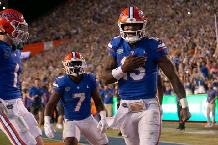 Anthony Richardson (15) celebrates after diving into the end zone for a touchdown.