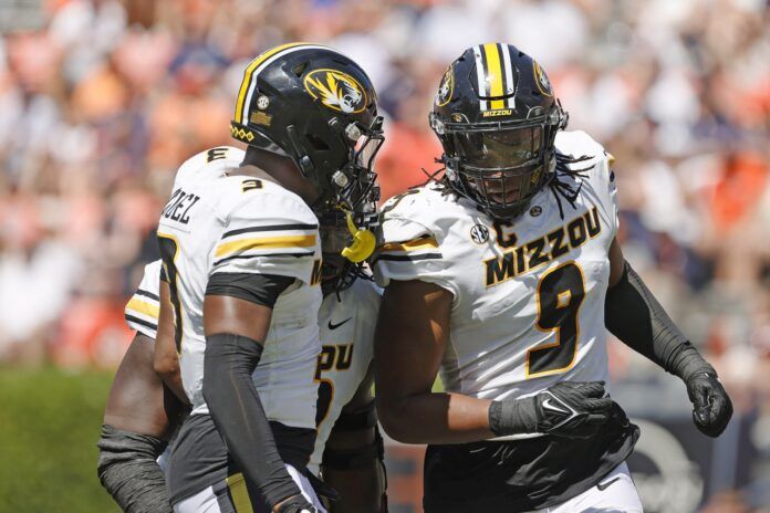 Isaiah McGuire (9) celebrates with defensive back Martez Manuel (3).