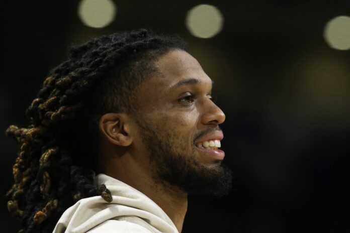 Buffalo Bills safety Damar Hamlin smiles after being spotted at a basketball game.