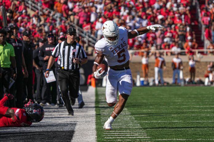 Bijan Robinson (5) runs the ball down the sideline during the game against Texas Tech.