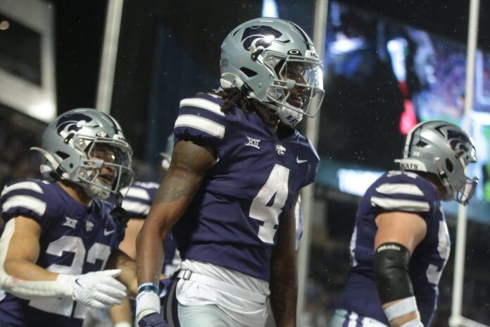 Malik Knowles (4) celebrates a touchdown over Kansas during the first quarter of Saturday's Sunflower Showdown at Bill Snyder Family Stadium.