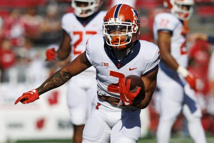 Chase Brown carries the football during warmups prior to the game against the Wisconsin Badgers.