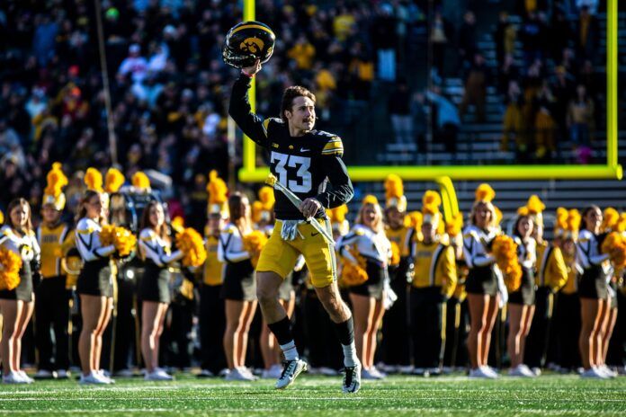 Riley Moss raises his helmet while being introduced for senior day.