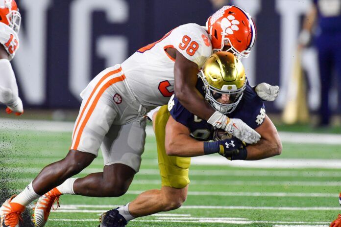 Clemson Tigers defensive lineman Myles Murphy (98) tackles Notre Dame Fighting Irish tight end Michael Mayer (87).