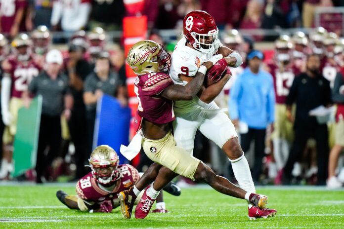 Florida State Seminoles defensive back Jammie Robinson (10) tackles Oklahoma Sooners tight end Brayden Willis (9).