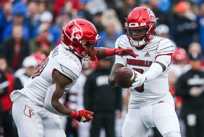 Louisville quarterback Malik Cunningham (3) hands off to Louisville running back Maurice Turner.