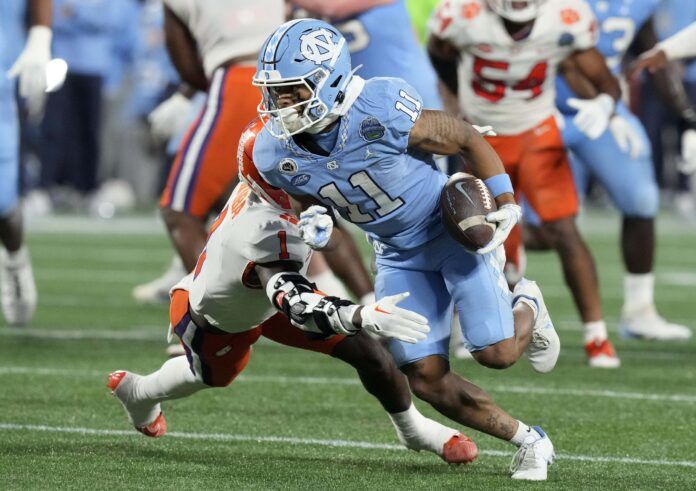 North Carolina Tar Heels wide receiver Josh Downs (11) runs past Clemson Tigers safety Andrew Mukuba (1).