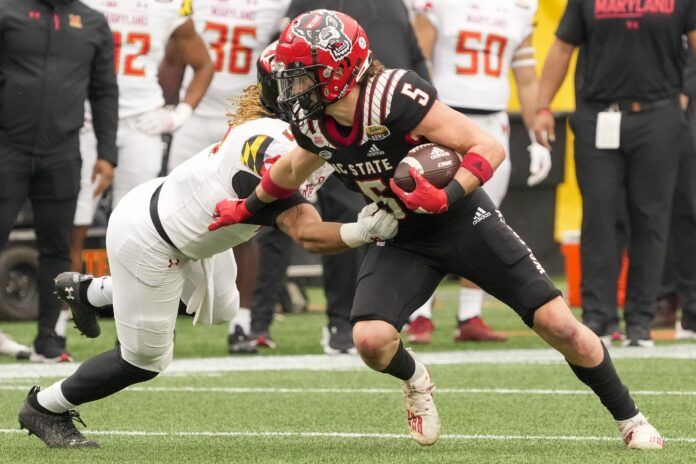 North Carolina State Wolfpack wide receiver Thayer Thomas (5) tries to elude Maryland Terrapins linebacker.