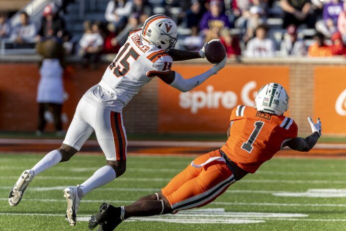 Anthony Johnson Jr. of Virginia intercepts a pass in front of National wide receiver Jayden Reed.